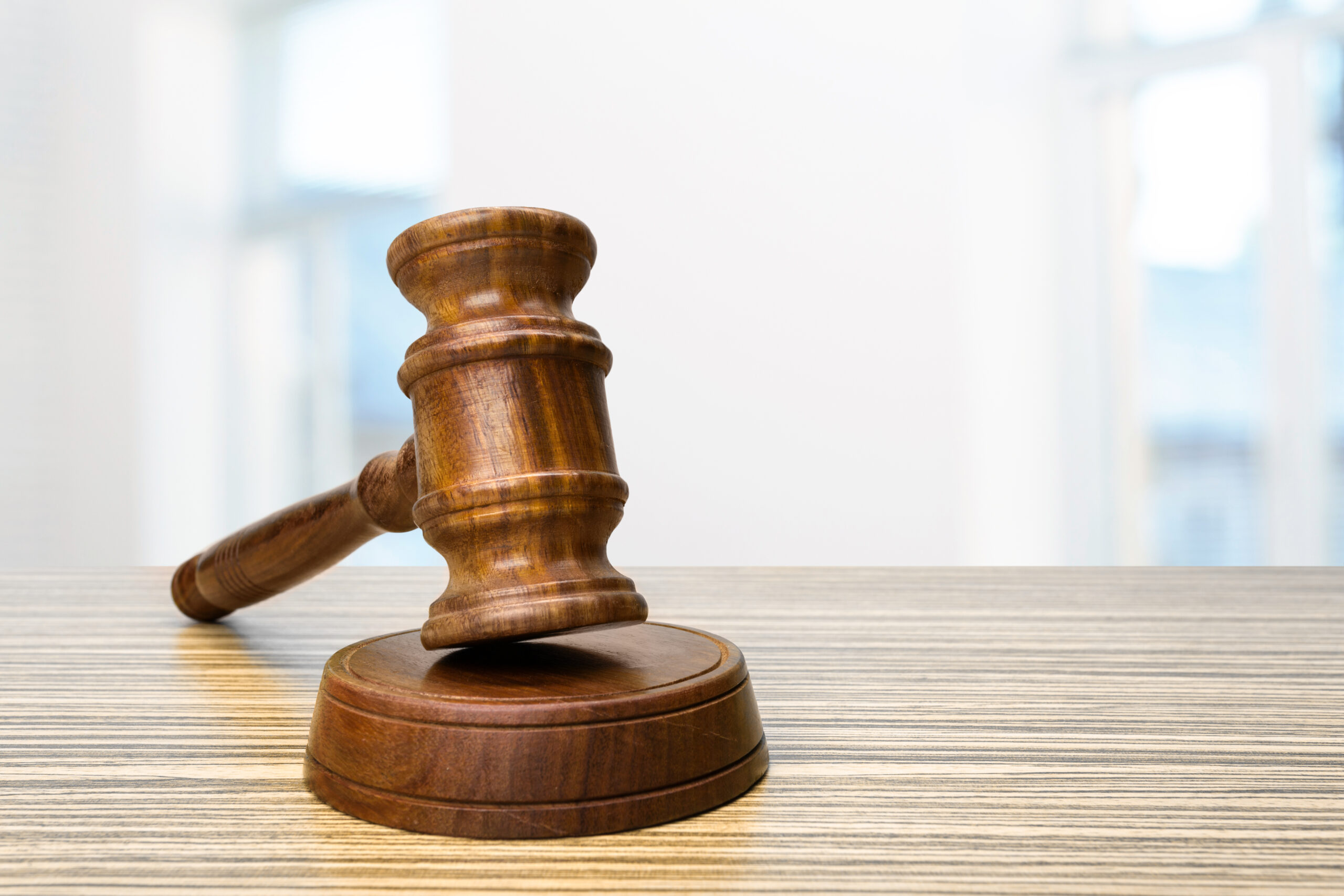 Wooden gavel on top of a table - Stevens Law Group